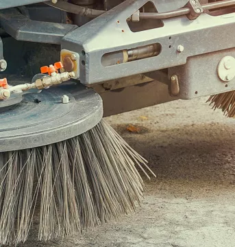 Close-up of a street sweeper brushes.