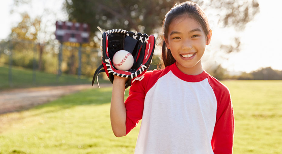 girl holding baseball glove and ball