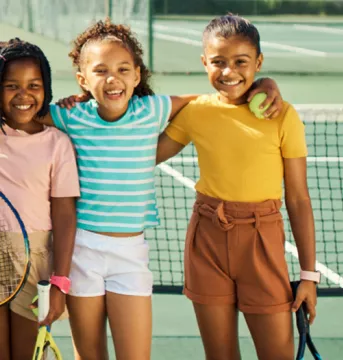 Children standing tennis court