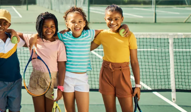 Children standing tennis court