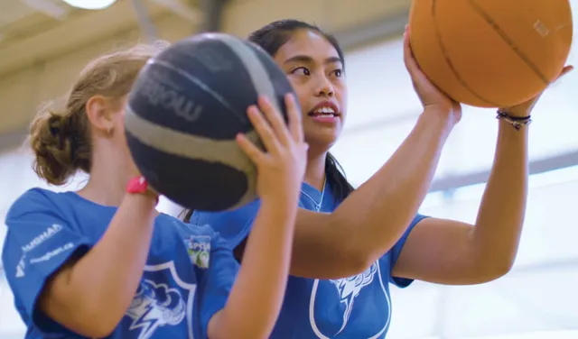 2 girls playing basketball