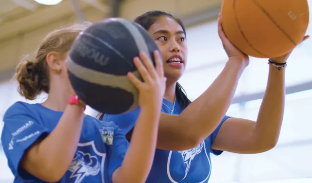 2 girls playing basketball
