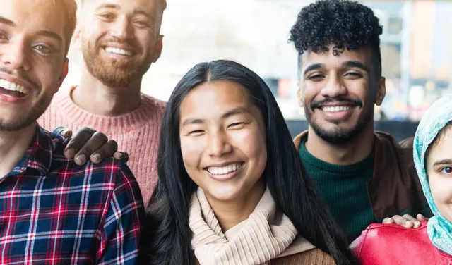 A group of young adults smiling