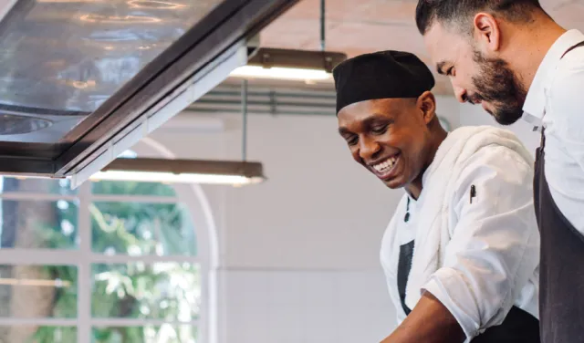 Two chefs cooking in a restaurant