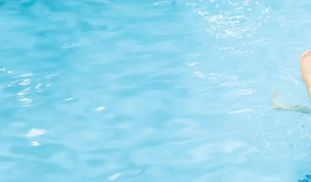 Instructor teaching a child how to swim