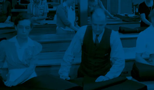 A photo of a group of factory workers with a dark blue overlay and red poppy