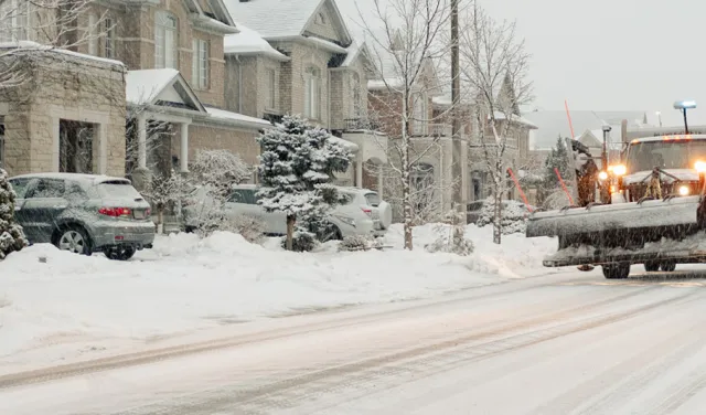 Snow plow going down a road