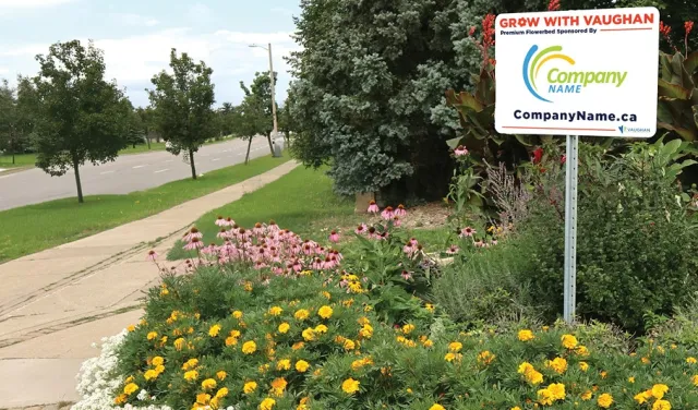 A flower bed with a sign