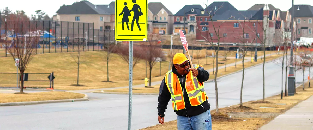 A crossing guard holding a stop-sign.