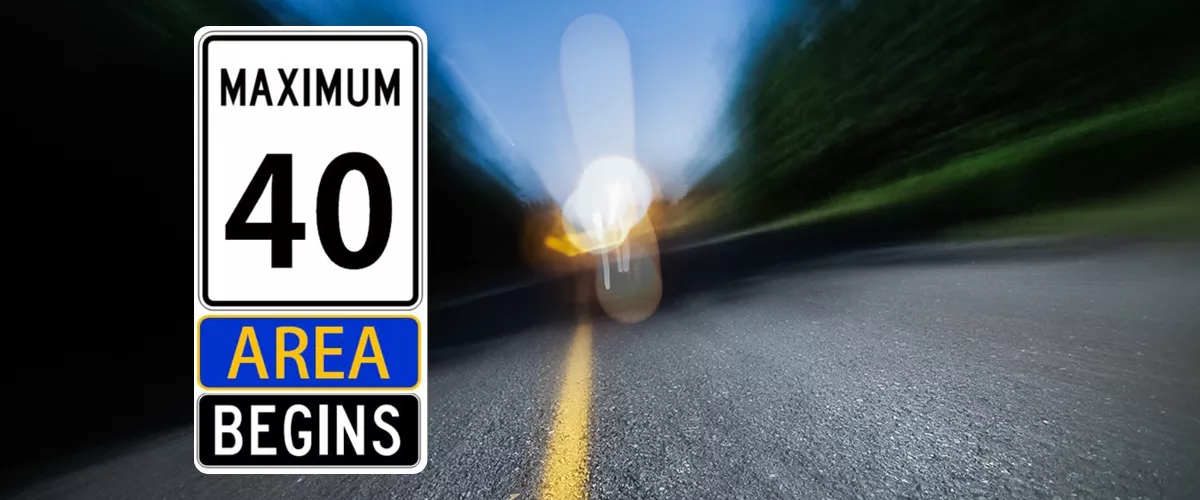 A speed limit sign with "MAXIMUM 40 AREA BEGINS" written on it.