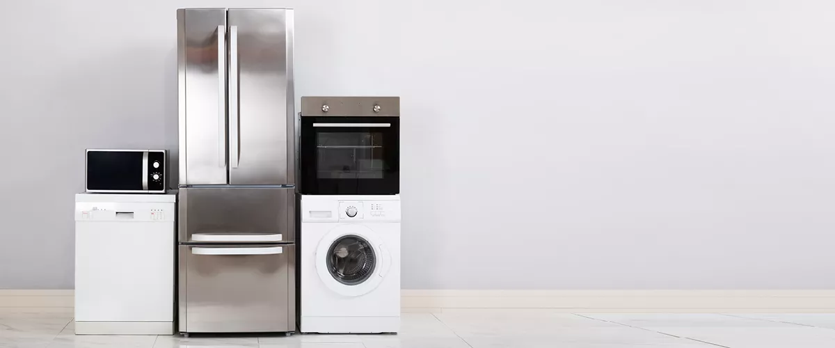 A microwave, dish washing machine, fridge, washer and stove.
