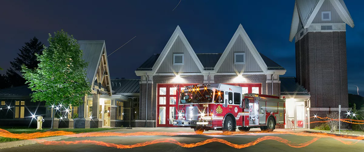 A fire station with a fire truck parked in the front.