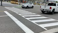 A picture of transverse markings across a street.
