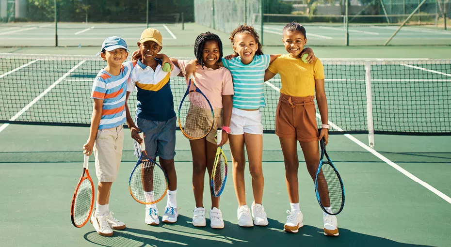 Five kids on a tennis court