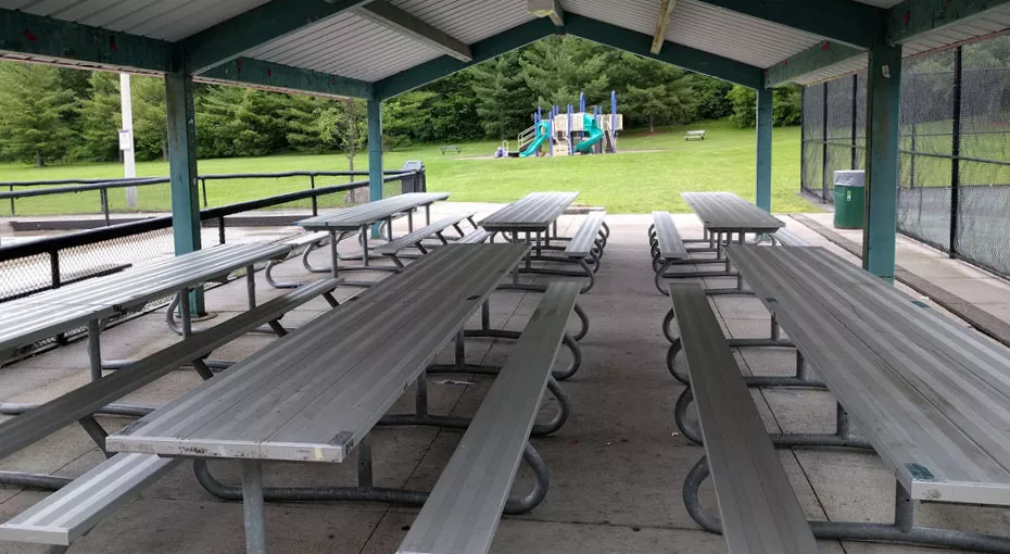 picnic tables under a gazebo in a park