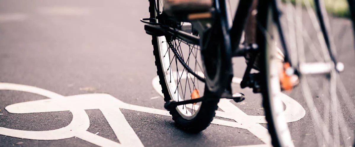 Image shows a bicycle riding on a bike lane