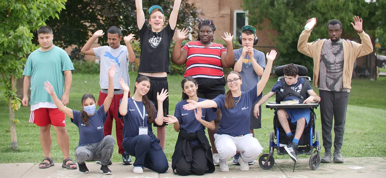 inclusion program participants playing outside with vaughan staff
