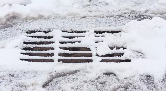 a catch basin covered in snow