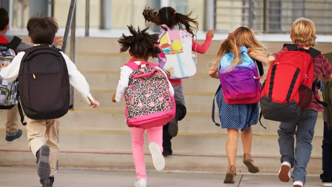 Kids running with backpacks