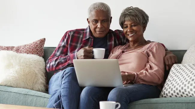 Two elderly looking at a computer screen