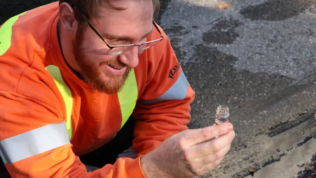 City staff holding a water sample