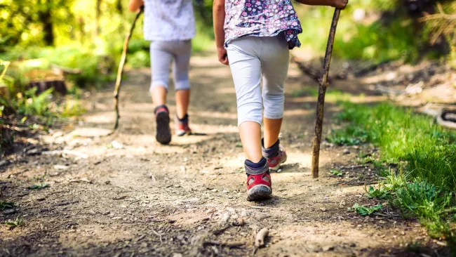 two people walking along a trail