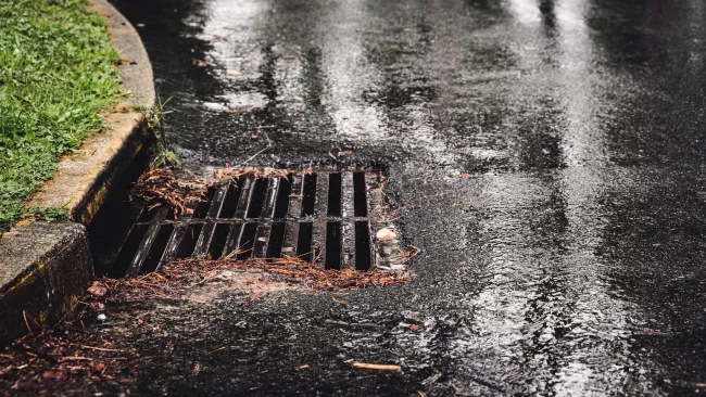 A catch basin on a rainy day