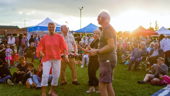 People dancing in a crowded park