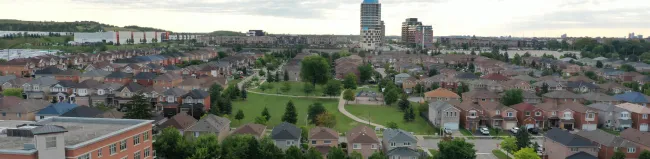 Aerial photograph of a community in Vaughan showing homes, greenspace and buildings in the background.