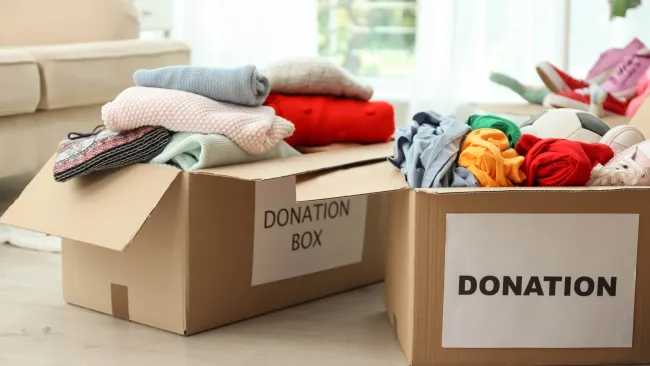 Small donation boxes full of clothes