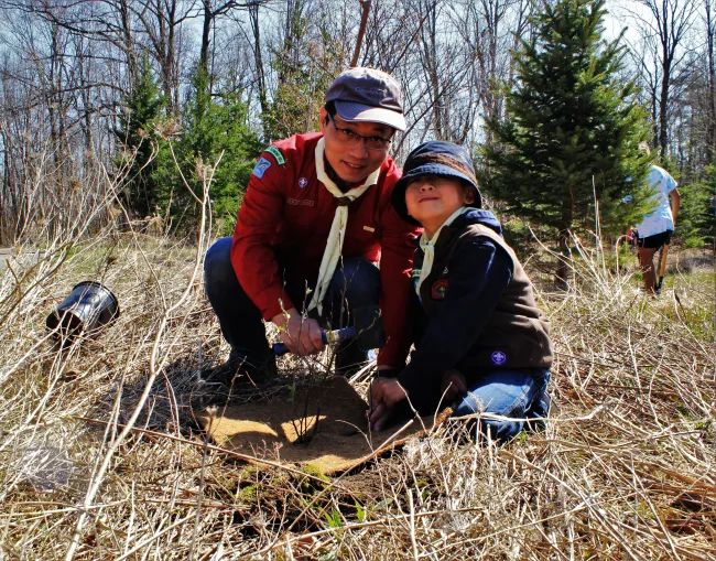 Father and son planting a tree