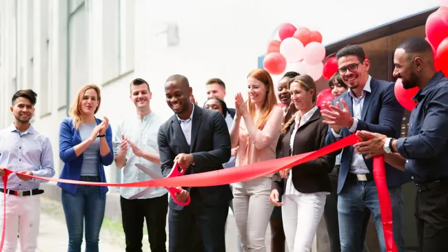 people cutting ribbon