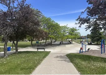 A bocce court with three lanes next to a playground.
