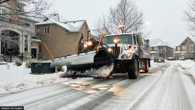 Snowplow in snowy neighbourhood
