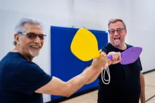 2 people holding pickleball raquets