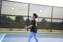 A boy learning to play pickleball