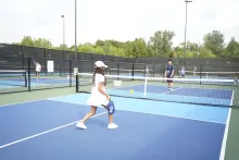 A girl learning to play pickleball
