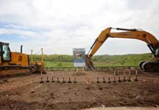 View of construction equipment and signage for future NMRP site at groundbreaking ceremony, 2017.
