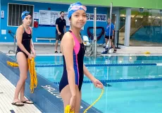 Child beside pool