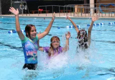 Three girls having fun in the outdoor pool.