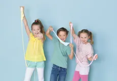 Three kids playing with slime