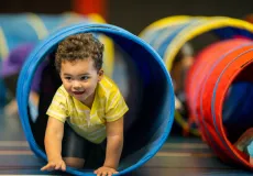 Toddler crawling through a tunnel