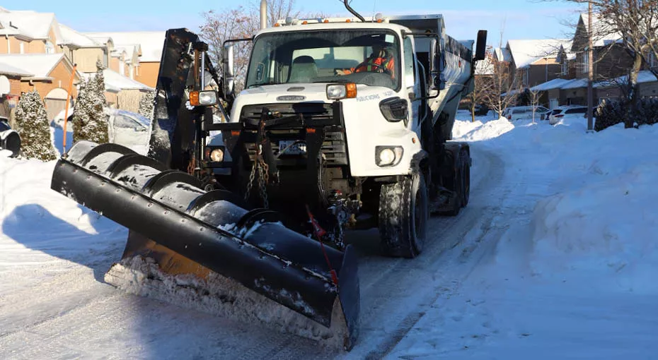 Truck plowing the street of snow