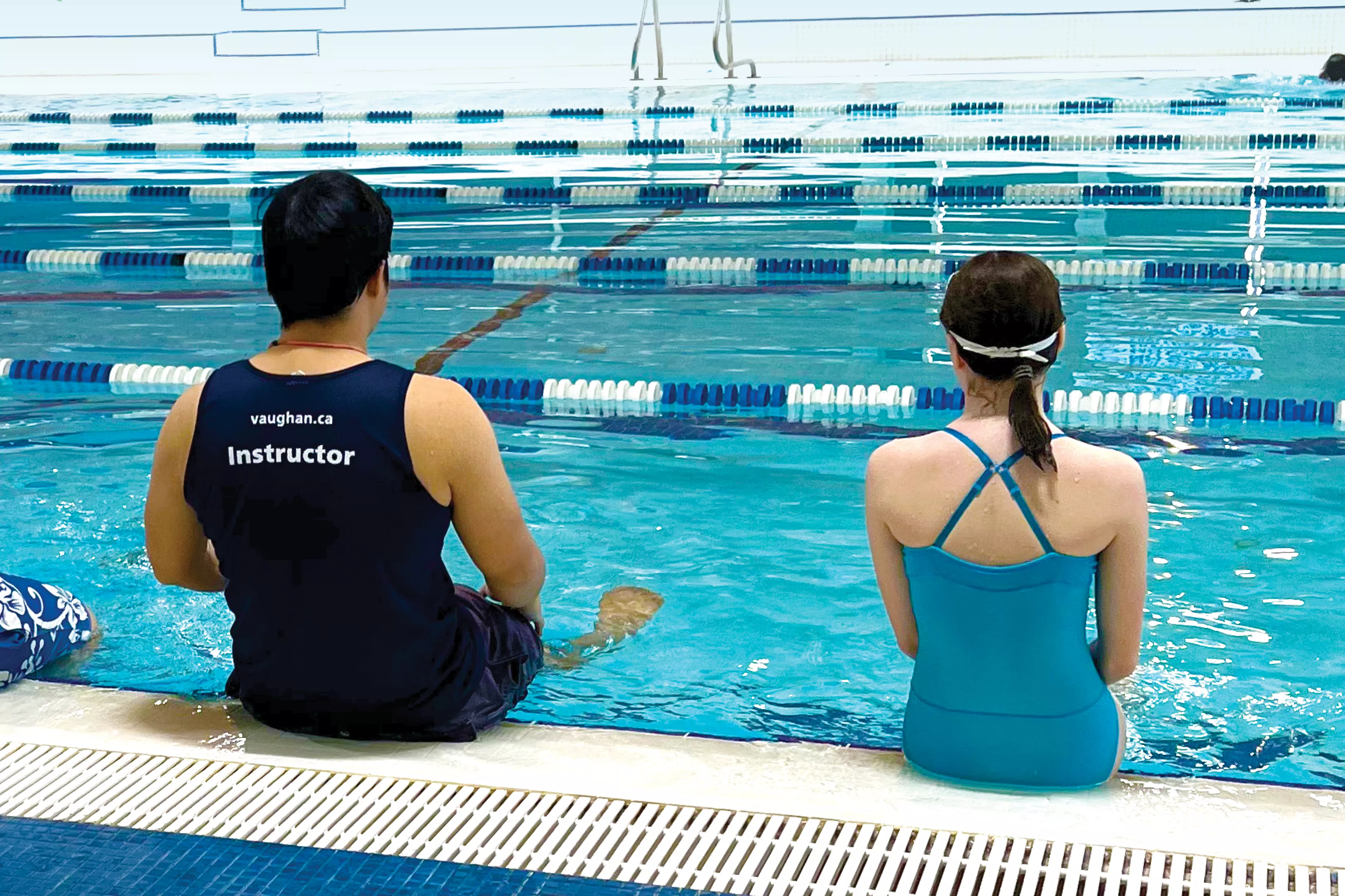 Child and instructor by the pool