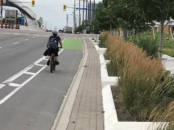 Image is of a Vaughan resident riding a bike in a bike lane. 