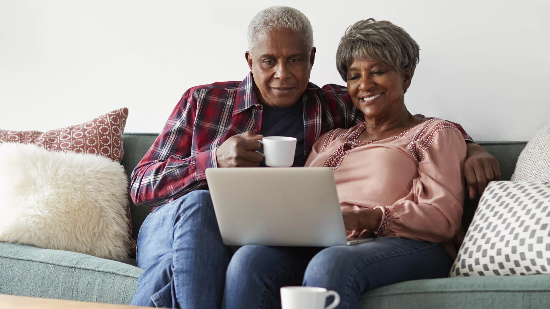 Two elderly looking at a computer screen