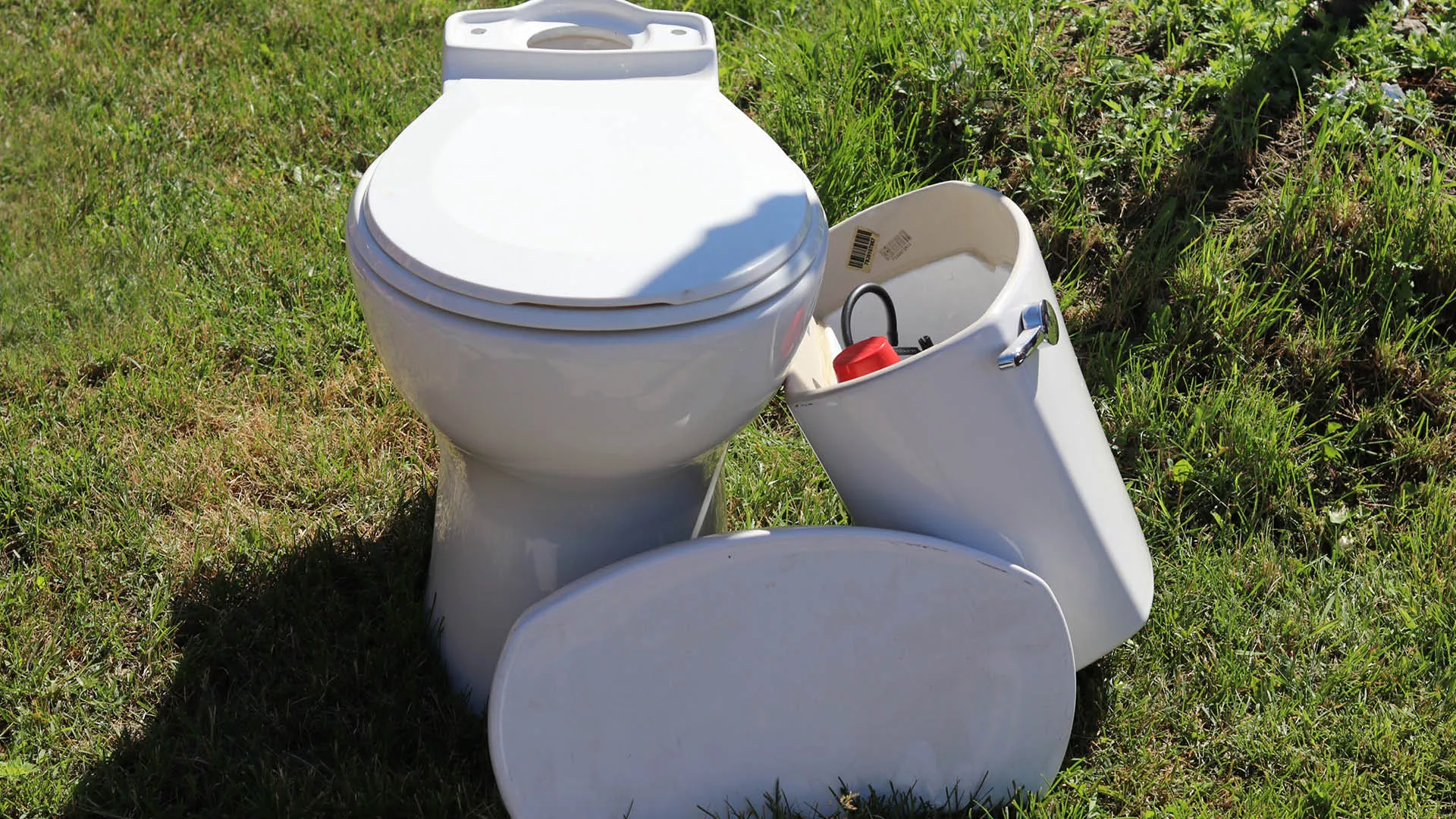 a two-piece toilet on grass