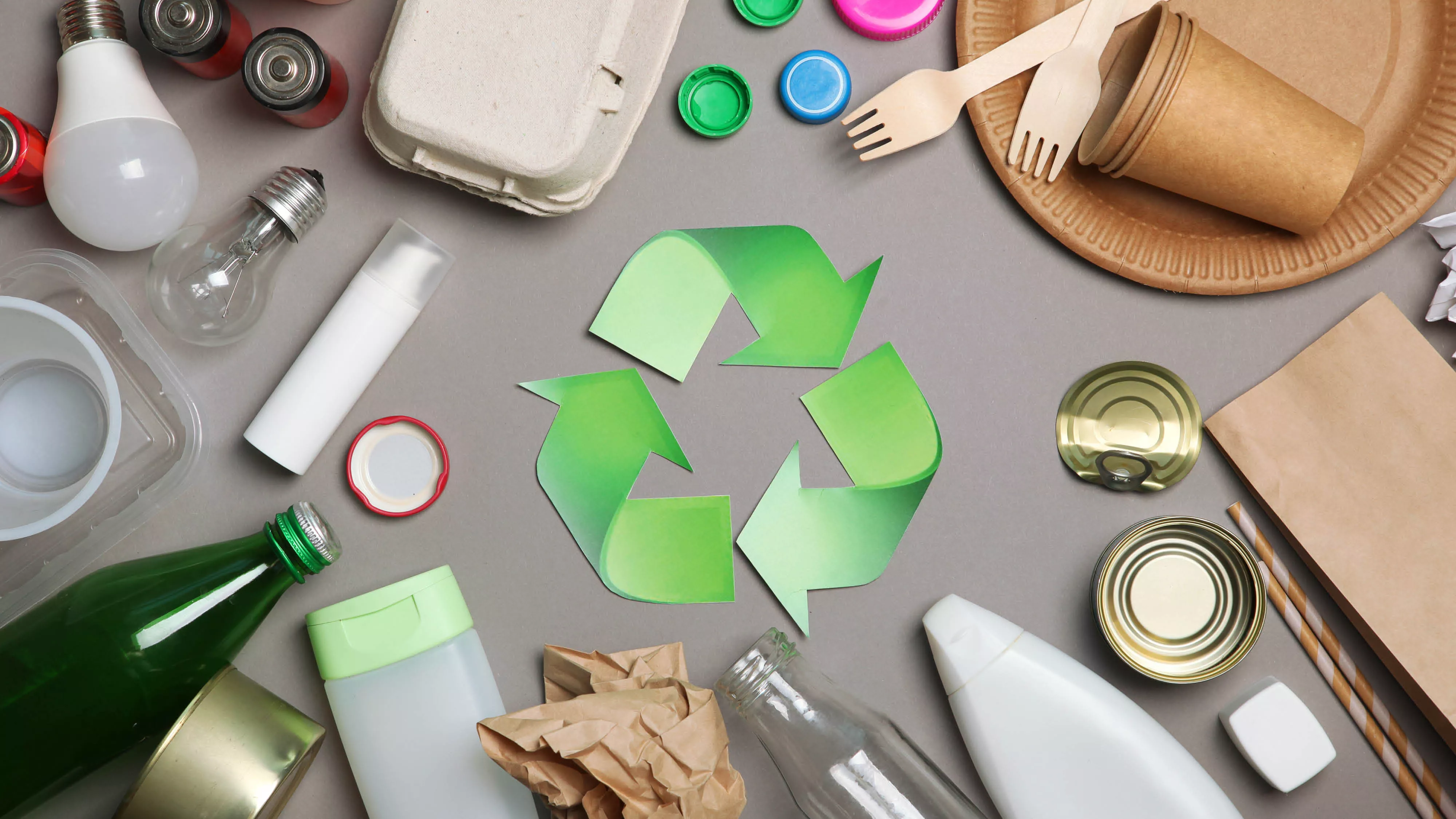 a variety of reusable materials around the recycle symbol