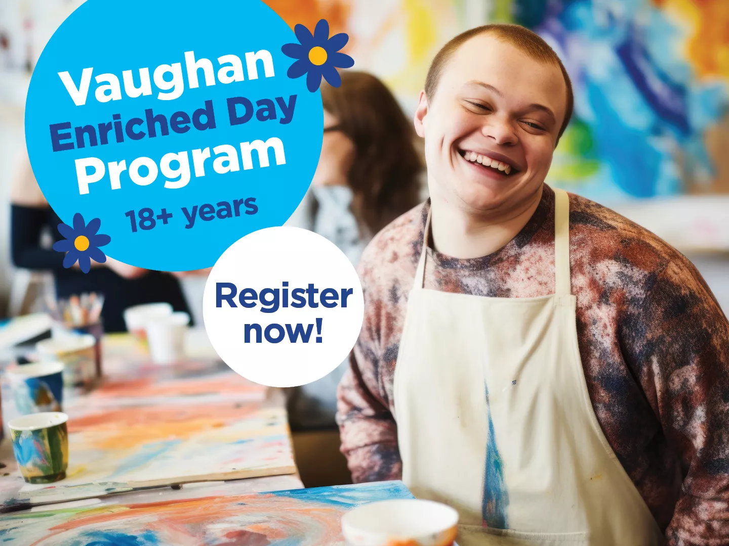 young adult with a disability smiling in a art class