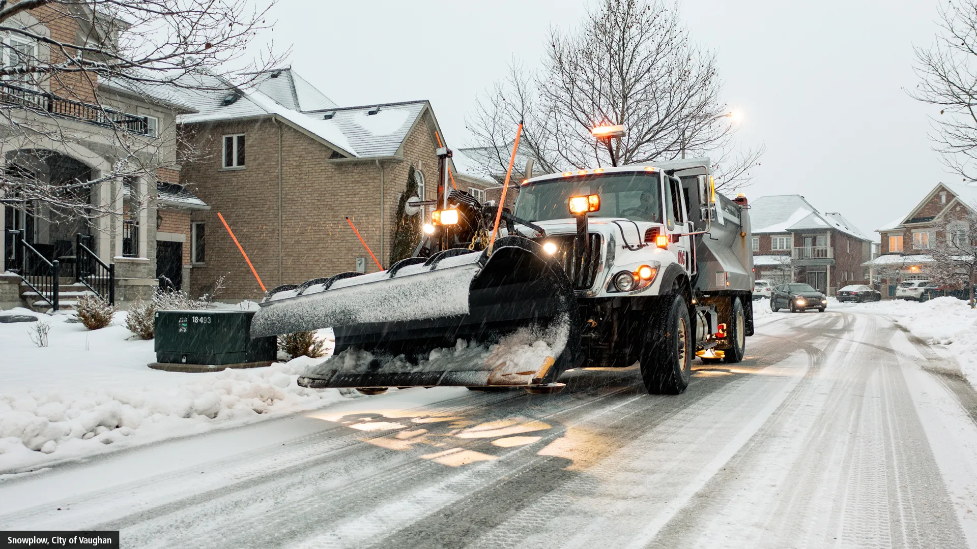 Snowplow in snowy neighbourhood